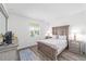 Comfortable bedroom with natural light and wood-look flooring at 7706 Sw 89Th Ct, Ocala, FL 34481