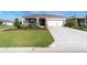 Charming single-story home featuring a well-maintained lawn, attractive landscaping, and an attached two-car garage at 7706 Sw 89Th Ct, Ocala, FL 34481