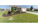 Inviting single-story home showcasing a lush green lawn, complemented by tastefully designed landscaping and a private driveway at 7706 Sw 89Th Ct, Ocala, FL 34481