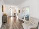 Welcoming foyer featuring wood-look floors, elegant lighting, and a glimpse into the bright, airy living spaces at 7706 Sw 89Th Ct, Ocala, FL 34481