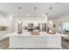 Stylish kitchen with stainless steel appliances, a spacious island, pendant lights, and ample counter space at 7706 Sw 89Th Ct, Ocala, FL 34481