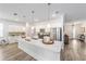 A modern kitchen featuring stainless steel appliances, an island with white countertop, and pendant lighting at 7706 Sw 89Th Ct, Ocala, FL 34481