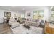 Comfortable living room with neutral decor, stylish furniture, and views to the lanai, perfect for relaxing or entertaining at 7706 Sw 89Th Ct, Ocala, FL 34481