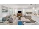 Spacious living room featuring ample seating, contemporary décor, and a seamless flow into the adjacent dining area at 7706 Sw 89Th Ct, Ocala, FL 34481