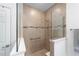 Modern tiled shower with glass enclosure and built-in bench at 7706 Sw 89Th Ct, Ocala, FL 34481