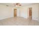 Spacious bedroom with tile flooring, closet, and access to the bathroom, creating a comfortable retreat at 8654 Sw 96Th St # D, Ocala, FL 34481