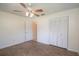 Bedroom with a ceiling fan, a double door closet, and easy access to the bathroom at 8654 Sw 96Th St # D, Ocala, FL 34481