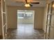 View into dining room featuring tile floors and backyard view framed by french doors at 8654 Sw 96Th St # D, Ocala, FL 34481