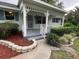 Inviting front porch featuring stone pathway, decorative stone retaining wall, and decorative bushes at 8654 Sw 96Th St # D, Ocala, FL 34481