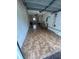 Spacious garage featuring patterned floor tiles, overhead storage, and ample room for vehicles at 8654 Sw 96Th St # D, Ocala, FL 34481