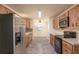 Kitchen featuring wooden cabinets, stainless steel appliances, and tiled floors at 8654 Sw 96Th St # D, Ocala, FL 34481