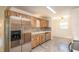 Kitchen featuring wooden cabinets, stainless steel appliances, tile flooring, and an adjacent dining area at 8654 Sw 96Th St # D, Ocala, FL 34481