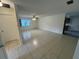 Open-concept living room with tile flooring, natural lighting, and a ceiling fan at 8654 Sw 96Th St # D, Ocala, FL 34481