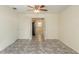 Open living room with tile flooring, ceiling fan, and view into the kitchen and dining area at 8654 Sw 96Th St # D, Ocala, FL 34481