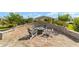 Brick patio with fire pit, seating, and landscaped surroundings at 8998 Sw 75Th Loop, Ocala, FL 34481