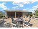 Rear exterior showcasing a brick patio, fire pit, and attractive landscaping at 8998 Sw 75Th Loop, Ocala, FL 34481