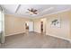 Spacious Primary bedroom with trey ceiling, wood-look floors, and neutral decor at 8998 Sw 75Th Loop, Ocala, FL 34481