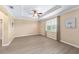 Primary bedroom with trey ceiling, ceiling fan, wood-look floors, and natural light at 8998 Sw 75Th Loop, Ocala, FL 34481