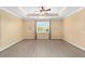 Large bedroom featuring wood-look floors, a trey ceiling, and natural light from the window at 8998 Sw 75Th Loop, Ocala, FL 34481