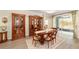 Charming dining area with classic wood furniture and views of the outdoor patio at 8998 Sw 75Th Loop, Ocala, FL 34481