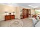 Elegant dining room with wood floors, decorative rug, built-in cabinets, and stylish furnishings at 8998 Sw 75Th Loop, Ocala, FL 34481