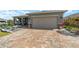 Charming home featuring a paver driveway, covered entry, and neutral color palette at 8998 Sw 75Th Loop, Ocala, FL 34481