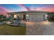 Lovely single-story home with a paved driveway, showcasing manicured landscaping and inviting front porch at 8998 Sw 75Th Loop, Ocala, FL 34481