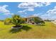 Well-maintained home exterior with lush landscaping and charming water feature at 8998 Sw 75Th Loop, Ocala, FL 34481