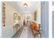 Inviting foyer with elegant decor, featuring a console table, decorative mirror, and stylish flooring at 8998 Sw 75Th Loop, Ocala, FL 34481