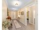 Bright and welcoming foyer showcasing stylish decor, wood flooring, and a view into other rooms at 8998 Sw 75Th Loop, Ocala, FL 34481