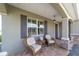Cozy front porch with comfortable seating, offering a welcoming entrance to this charming single-story home at 8998 Sw 75Th Loop, Ocala, FL 34481