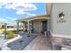Inviting front porch of a single-story home with seating area, decorative stonework, and manicured landscaping at 8998 Sw 75Th Loop, Ocala, FL 34481