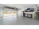 Spacious two-car garage with epoxy flooring and ample storage cabinets at 8998 Sw 75Th Loop, Ocala, FL 34481