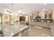 Spacious kitchen featuring gray cabinets, granite counters, tile backsplash, and stainless appliances at 8998 Sw 75Th Loop, Ocala, FL 34481
