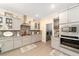 Bright kitchen with granite countertops, stainless steel appliances, and gray cabinets at 8998 Sw 75Th Loop, Ocala, FL 34481