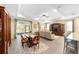 Bright, open living area with elegant furniture, wood floors, and access to the outdoor patio at 8998 Sw 75Th Loop, Ocala, FL 34481