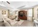 Cozy living room featuring neutral-toned furnishings and a large, decorative wood entertainment center at 8998 Sw 75Th Loop, Ocala, FL 34481