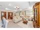 Spacious living room with comfortable seating, wood-style flooring, and a view of the dining area at 8998 Sw 75Th Loop, Ocala, FL 34481