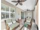 Covered patio featuring comfortable wicker seating and ceiling fans at 8998 Sw 75Th Loop, Ocala, FL 34481