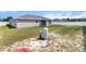 View of the home's exterior showing the lawn, fencing and back patio space at 9 Walnut Run, Ocala, FL 34480