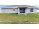 Home exterior showing back patio with sliding glass doors and the yard at 9 Walnut Run, Ocala, FL 34480