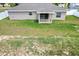 Home exterior featuring a covered patio, large yard, and lush green grass at 9 Walnut Run, Ocala, FL 34480