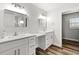 Bright bathroom featuring double sinks, white cabinetry, and modern fixtures at 9 Walnut Run, Ocala, FL 34480