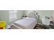 Cozy bedroom with a decorative tufted headboard, vintage furniture, and ample natural light at 9 Walnut Run, Ocala, FL 34480