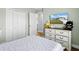 Comfortable bedroom featuring muted walls and a chest of drawers with a television at 9 Walnut Run, Ocala, FL 34480