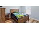 A tidy bedroom featuring a wood-framed bed and laminate wood flooring at 9 Walnut Run, Ocala, FL 34480