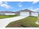 Lovely single-story home featuring an attached two-car garage, a well-manicured lawn, and a spacious driveway at 9 Walnut Run, Ocala, FL 34480