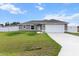 Charming single-story home featuring a two-car garage, well-manicured lawn, and a classic architectural design at 9 Walnut Run, Ocala, FL 34480