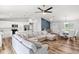 Spacious living area featuring modern lighting, sleek kitchen, and cozy furniture for comfortable living at 9 Walnut Run, Ocala, FL 34480