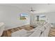 Bright living space with wood floors, large sectional and tv with an outside view enhancing the room's aesthetic at 9 Walnut Run, Ocala, FL 34480